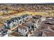 Aerial view of a modern townhome community with landscaped grounds, walking trails, and neighborhood park at 5738 Urban Ctr, Arvada, CO 80002