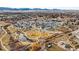 Aerial view of a neighborhood with parks, ponds, and walking trails in a valley surrounded by mountains at 5738 Urban Ctr, Arvada, CO 80002