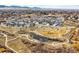 A high, aerial perspective of the neighborhood with walking trails, a pond, and mountain views at 5738 Urban Ctr, Arvada, CO 80002