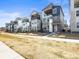 Modern townhomes showcasing stylish architectural details and landscaping on a sunny day at 5738 Urban Ctr, Arvada, CO 80002