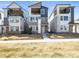 Exterior view of modern townhomes with private balconies and sleek design elements at 5738 Urban Ctr, Arvada, CO 80002