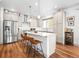 Bright kitchen featuring stainless steel appliances and a large island with a granite countertop at 5738 Urban Ctr, Arvada, CO 80002