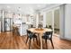 Modern kitchen adjacent to dining area with stainless steel appliances and granite countertops at 5738 Urban Ctr, Arvada, CO 80002