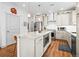 Well-lit kitchen features granite countertops, stainless steel appliances, and custom cabinets at 5738 Urban Ctr, Arvada, CO 80002