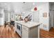 Open kitchen and dining area featuring granite countertops, stainless steel microwave in the island, and natural light at 5738 Urban Ctr, Arvada, CO 80002