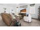 Cozy living room featuring a brown leather sofa, chairs, and stylish decor accents at 5738 Urban Ctr, Arvada, CO 80002