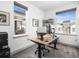 Bright home office featuring a modern adjustable desk, ergonomic chair, and plenty of natural light at 5738 Urban Ctr, Arvada, CO 80002