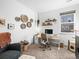 Cozy home office featuring a modern desk, comfortable chair, and decorative wall art for an inspiring workspace at 5738 Urban Ctr, Arvada, CO 80002