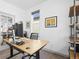 A bright home office area with an adjustable desk, ergonomic chair, and modern computer equipment at 5738 Urban Ctr, Arvada, CO 80002