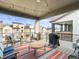 Cozy patio with outdoor seating, grill, and view of surrounding homes under a blue sky at 5738 Urban Ctr, Arvada, CO 80002