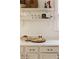 Kitchen counter with marble countertops, white cabinets, and charming display shelves above at 321 Fox St, Denver, CO 80223