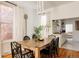 Bright dining room with hardwood floors, large windows, wooden table and access to the Kitchen at 321 Fox St, Denver, CO 80223