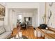 Bright dining room with hardwood floors, large windows, and a view into the adjoining kitchen at 321 Fox St, Denver, CO 80223