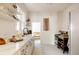 Clean kitchen featuring white cabinetry, open shelving, stylish flooring, and updated appliances at 321 Fox St, Denver, CO 80223