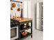 Charming kitchen with stainless steel fridge and movable island with butcher block countertop at 321 Fox St, Denver, CO 80223