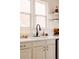 Bright kitchen featuring a white sink, black faucet, marble countertops and plentiful natural light at 321 Fox St, Denver, CO 80223