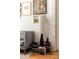 Comfortable room with reading lamp atop a stack of books, and a view of the hardwood floors at 321 Fox St, Denver, CO 80223