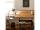 Bright home office with drafting table, vintage stool, decorative rug and bright light at 321 Fox St, Denver, CO 80223