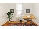Bright home office with drafting table, vintage stool, decorative rug and bright light at 321 Fox St, Denver, CO 80223