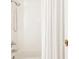 Clean, white tiled shower with modern fixtures and a glass door at 321 Fox St, Denver, CO 80223