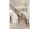 Elegant curved staircase with wrought iron railings and light wood flooring at 2111 E Alameda Ave, Denver, CO 80209