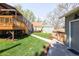 Spacious backyard featuring a deck, a lush lawn, and a concrete pathway at 2520 S Race St, Denver, CO 80210