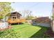 Spacious backyard featuring deck, lawn, storage shed, and mature trees at 2520 S Race St, Denver, CO 80210
