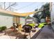 Inviting backyard patio with a fire pit, stylish furniture and shade cover for outdoor entertaining at 2520 S Race St, Denver, CO 80210