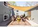 Inviting backyard patio with a fire pit, stylish furniture and shade cover for outdoor entertaining at 2520 S Race St, Denver, CO 80210