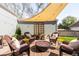 Inviting backyard patio with a fire pit, stylish furniture and shade cover for outdoor entertaining at 2520 S Race St, Denver, CO 80210