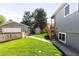 Backyard with mature trees, lawn, detached garage, and storage shed at 2520 S Race St, Denver, CO 80210