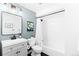 Updated bathroom with a gray vanity, tub/shower combo, and modern fixtures at 2520 S Race St, Denver, CO 80210