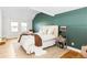 Comfortable bedroom with hardwood floors, neutral decor, and lots of natural light at 2520 S Race St, Denver, CO 80210