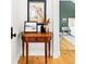 Hallway with wood floors and a decorative table leading into the bedroom at 2520 S Race St, Denver, CO 80210