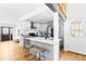 Modern kitchen with white countertops, gray cabinets, stainless appliances, hardwood floors, and barstool seating at 2520 S Race St, Denver, CO 80210