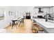 Open concept kitchen with white cabinets, quartz counters, stainless appliances, and an adjacent dining area at 2520 S Race St, Denver, CO 80210
