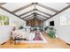 Spacious living room with vaulted ceilings, exposed beams, hardwood floors, and lots of natural light at 2520 S Race St, Denver, CO 80210