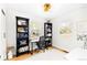Bright home office featuring hardwood floors, black bookshelves, and natural light at 2520 S Race St, Denver, CO 80210