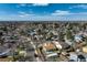 Expansive aerial view shows the neighborhood and distant mountains under a blue sky at 19000 E Mansfield Dr, Aurora, CO 80013