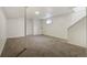 Finished basement features carpet, painted walls, small window and support pole at 19000 E Mansfield Dr, Aurora, CO 80013