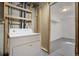 Laundry area with a washing machine in an unfinished basement at 19000 E Mansfield Dr, Aurora, CO 80013