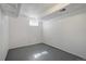 Bare basement room featuring painted floor and drop-down ceiling fixture at 19000 E Mansfield Dr, Aurora, CO 80013