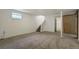 Finished basement features carpet, painted walls, small window, stair access to upper level at 19000 E Mansfield Dr, Aurora, CO 80013