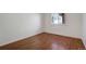 This bedroom features wood floors, white walls, base trim and a window at 19000 E Mansfield Dr, Aurora, CO 80013
