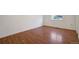 This bedroom features wood floors, white walls, base trim and a window at 19000 E Mansfield Dr, Aurora, CO 80013