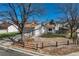 Charming home with a gray exterior, spacious driveway, and beautifully landscaped front yard at 19000 E Mansfield Dr, Aurora, CO 80013