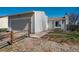 Charming single-Gathering home featuring a gray exterior, attached garage, and lovely landscaping at 19000 E Mansfield Dr, Aurora, CO 80013