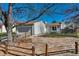 Quaint home features a gray exterior, well-maintained lawn, and a welcoming front entrance at 19000 E Mansfield Dr, Aurora, CO 80013
