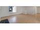 Living room featuring hardwood floors, large window, white walls, and a staircase at 19000 E Mansfield Dr, Aurora, CO 80013