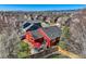 Aerial view of a red home with a backyard patio, set amidst a neighborhood with mountain views at 9408 High Cliffe St, Highlands Ranch, CO 80129